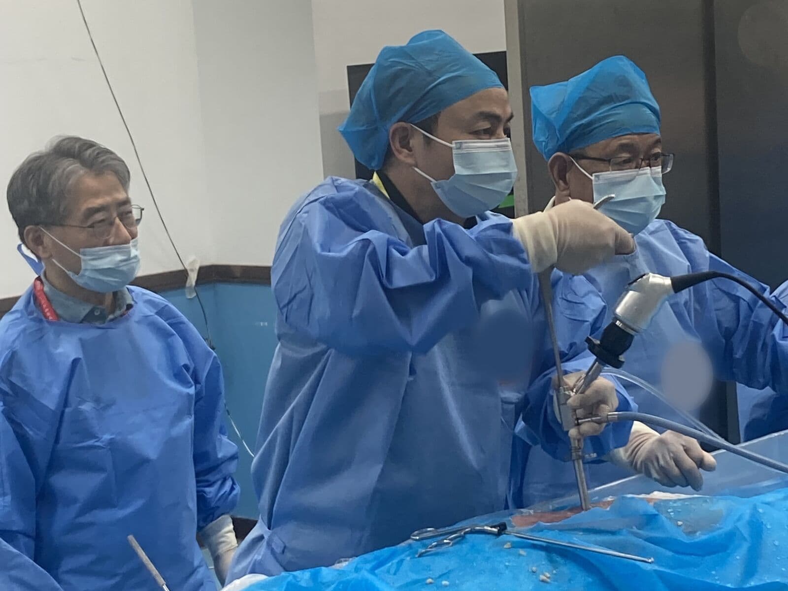 Trainee surgeons practicing endoscopic technique in a cadaver lab with faculty mentorship